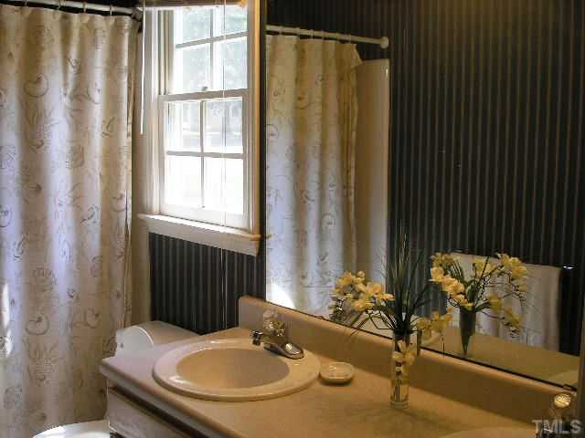 6301 Cape Charles Drive Raleigh, NC 27617 - Photo 12 of 19 a bathroom with a sink and a mirror