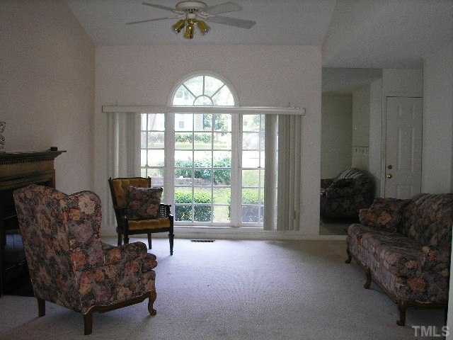 6301 Cape Charles Drive Raleigh, NC 27617 - Photo 3 of 19 a living room with furniture and a floor to ceiling window