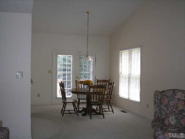 6301 Cape Charles Drive Raleigh, NC 27617 - Photo 5 of 19 a view of a dining room with furniture window and outside view