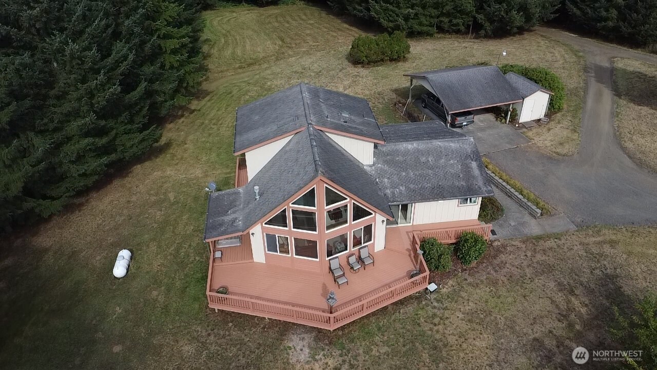 an aerial view of a house with a yard