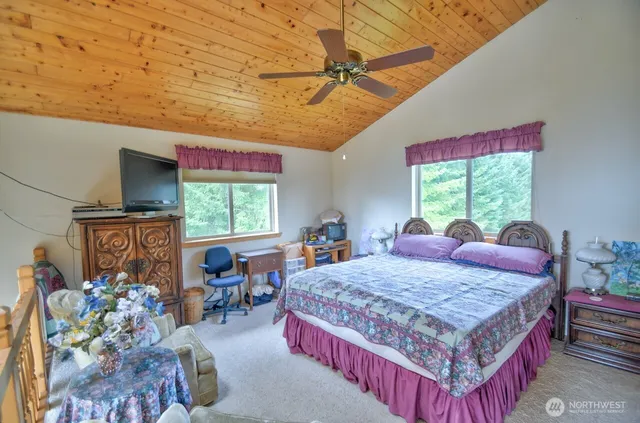 a bed room with a bed window and a table