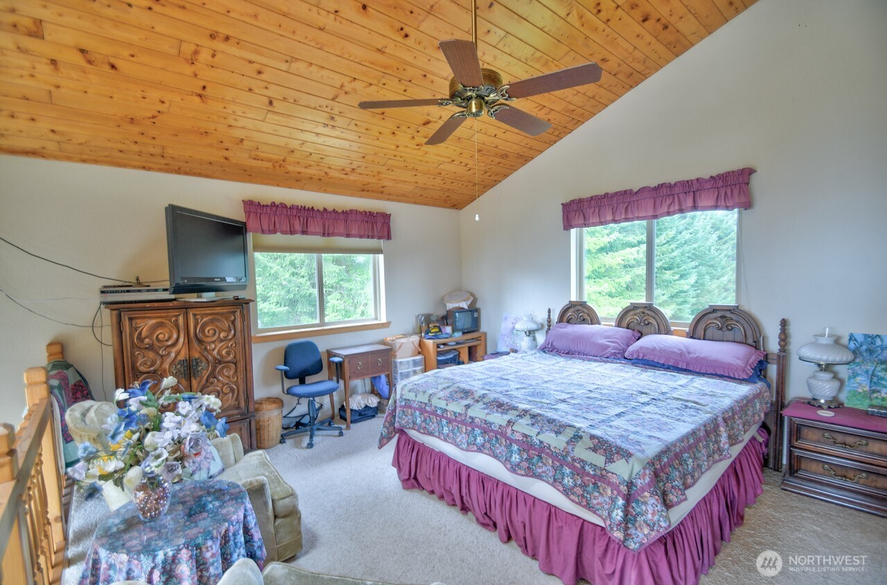 378 Burnt Ridge Road Onalaska, WA 98570 - Photo 13 of 40 a bed room with a bed window and a table