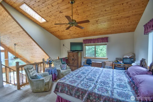 a bed room with a bed and large window