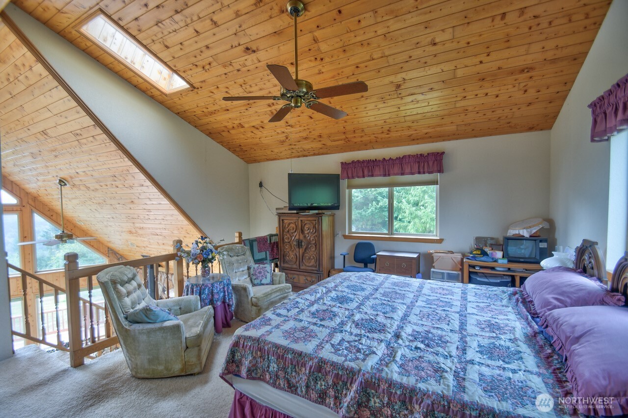 378 Burnt Ridge Road Onalaska, WA 98570 - Photo 14 of 40 a bed room with a bed and large window