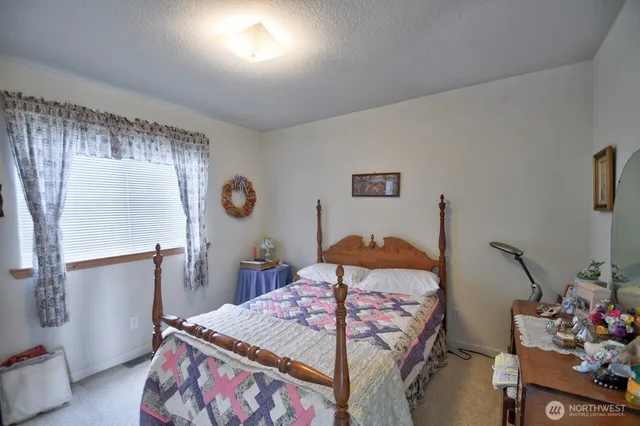 a bedroom with a bed and a dresser in it