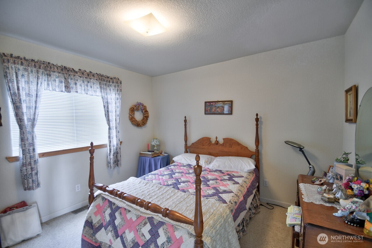 378 Burnt Ridge Road Onalaska, WA 98570 - Photo 18 of 40 a bedroom with a bed and a dresser in it