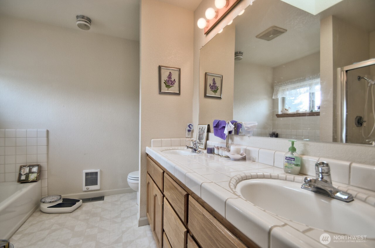 378 Burnt Ridge Road Onalaska, WA 98570 - Photo 19 of 40 a bathroom with a granite countertop double vanity sink and a mirror