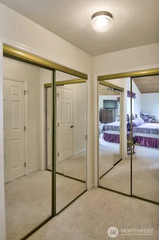 a bathroom with a granite countertop sink mirror and shower