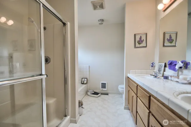 a bathroom with a sink toilet and shower