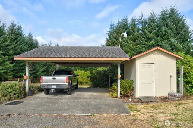 a view of a house with a yard and sitting area