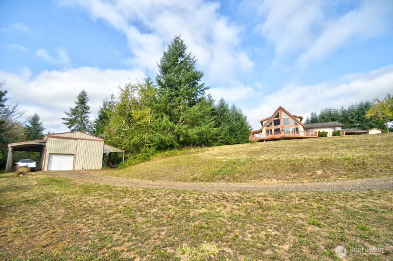 378 Burnt Ridge Road Onalaska, WA 98570 - Photo 26 of 40 a view of a house with a yard and sitting area