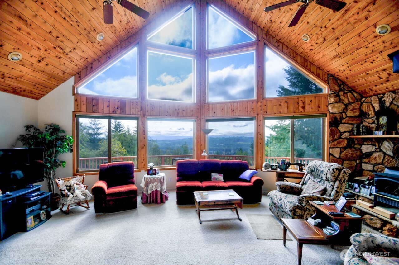 378 Burnt Ridge Road Onalaska, WA 98570 - Photo 4 of 40 a living room with patio furniture and a potted plants