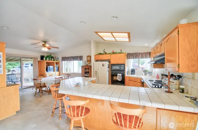 a living room with furniture a large window and chairs