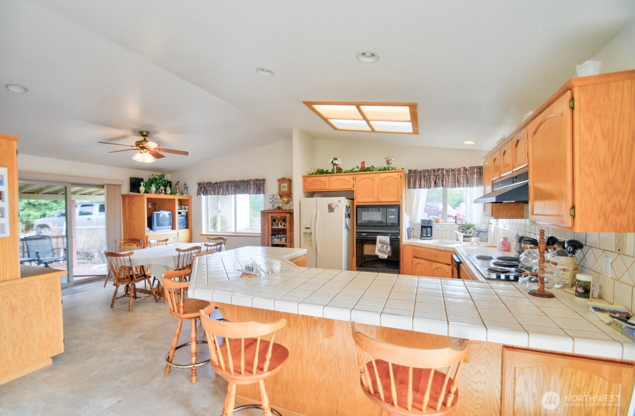378 Burnt Ridge Road Onalaska, WA 98570 - Photo 8 of 40 a living room with furniture a large window and chairs