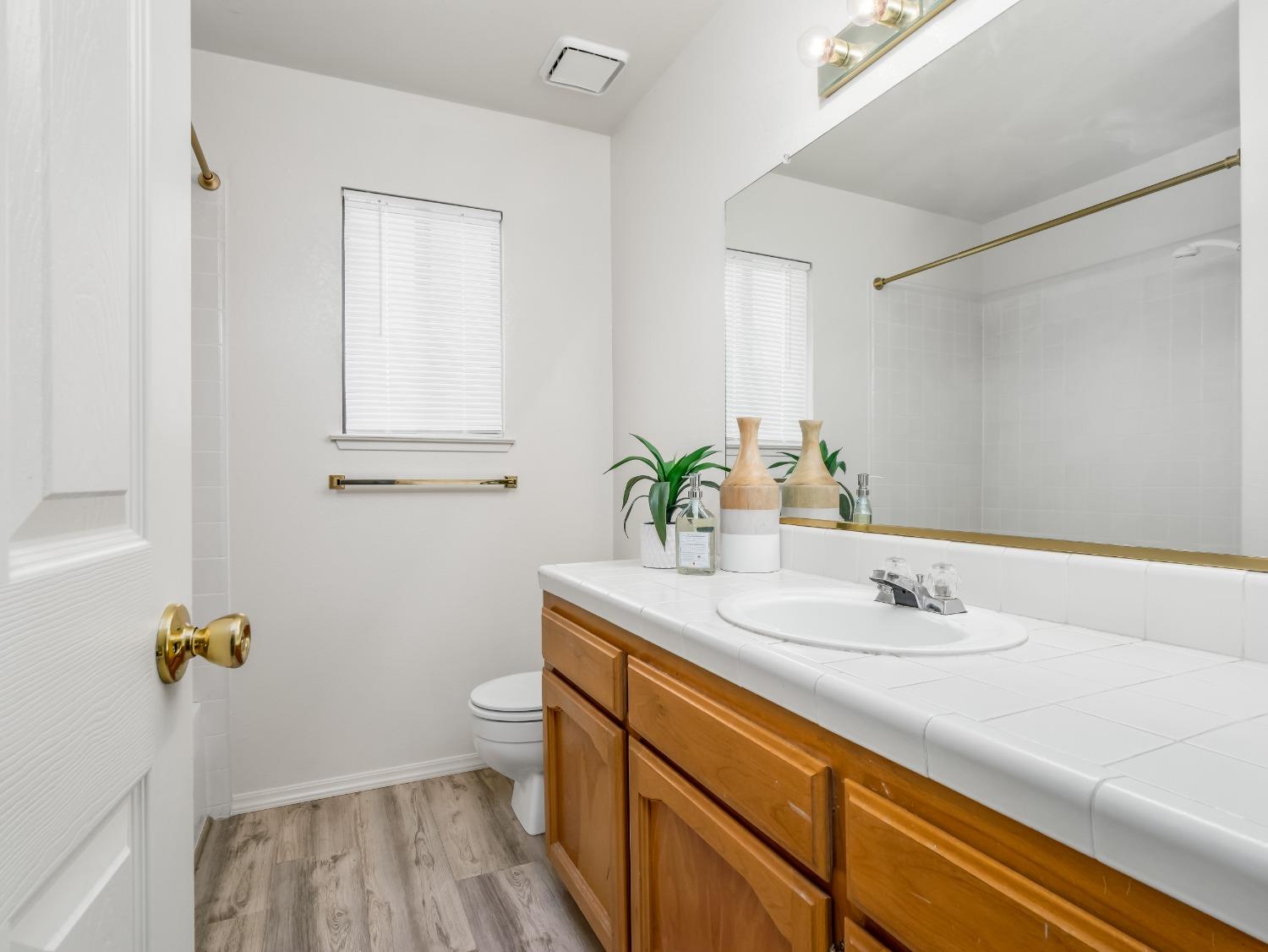 2048 Maple Street Selma, CA 93662 - Photo 12 of 20 a bathroom with a sink and a mirror