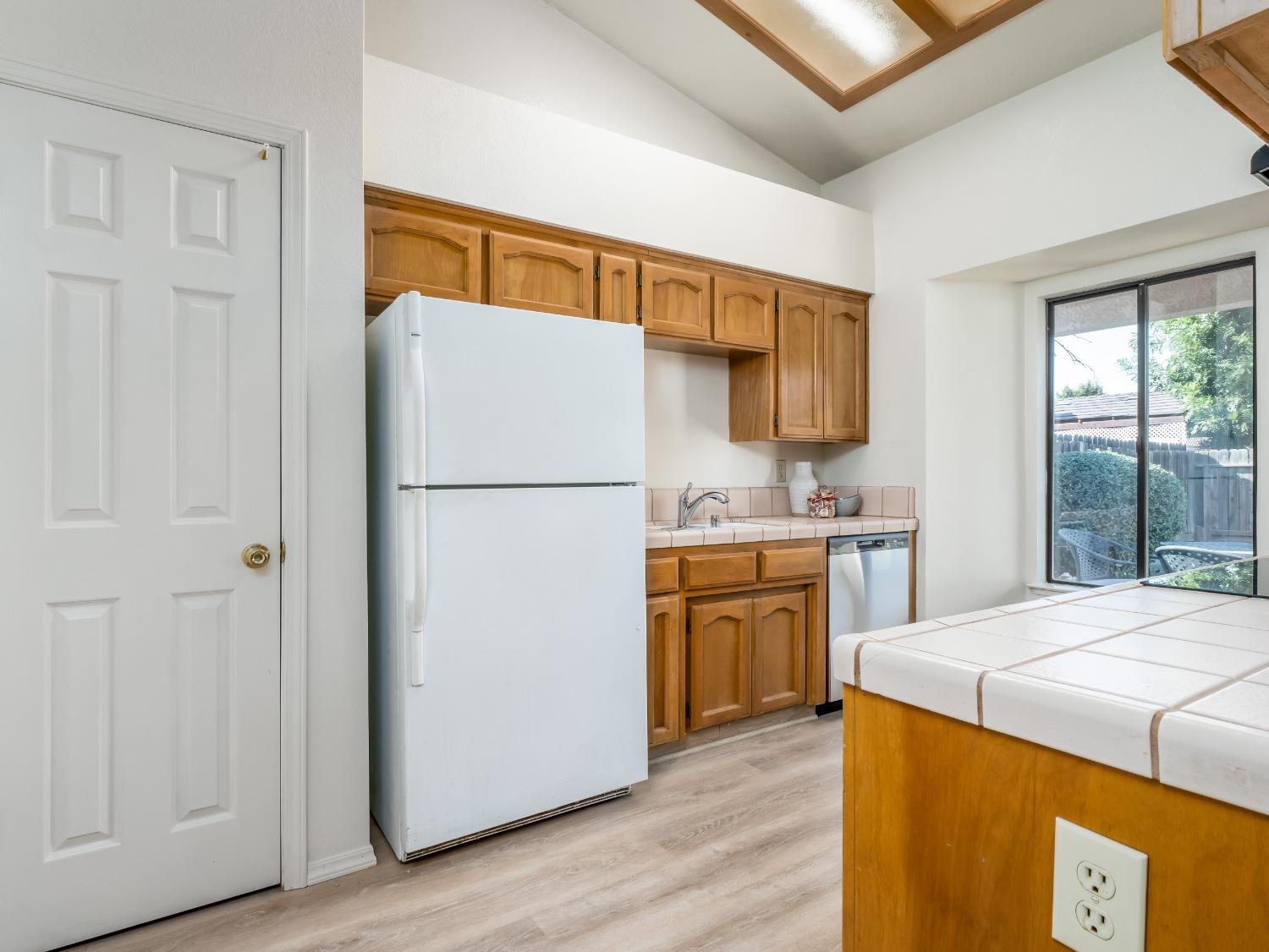 2048 Maple Street Selma, CA 93662 - Photo 5 of 20 a kitchen with a refrigerator sink and stove