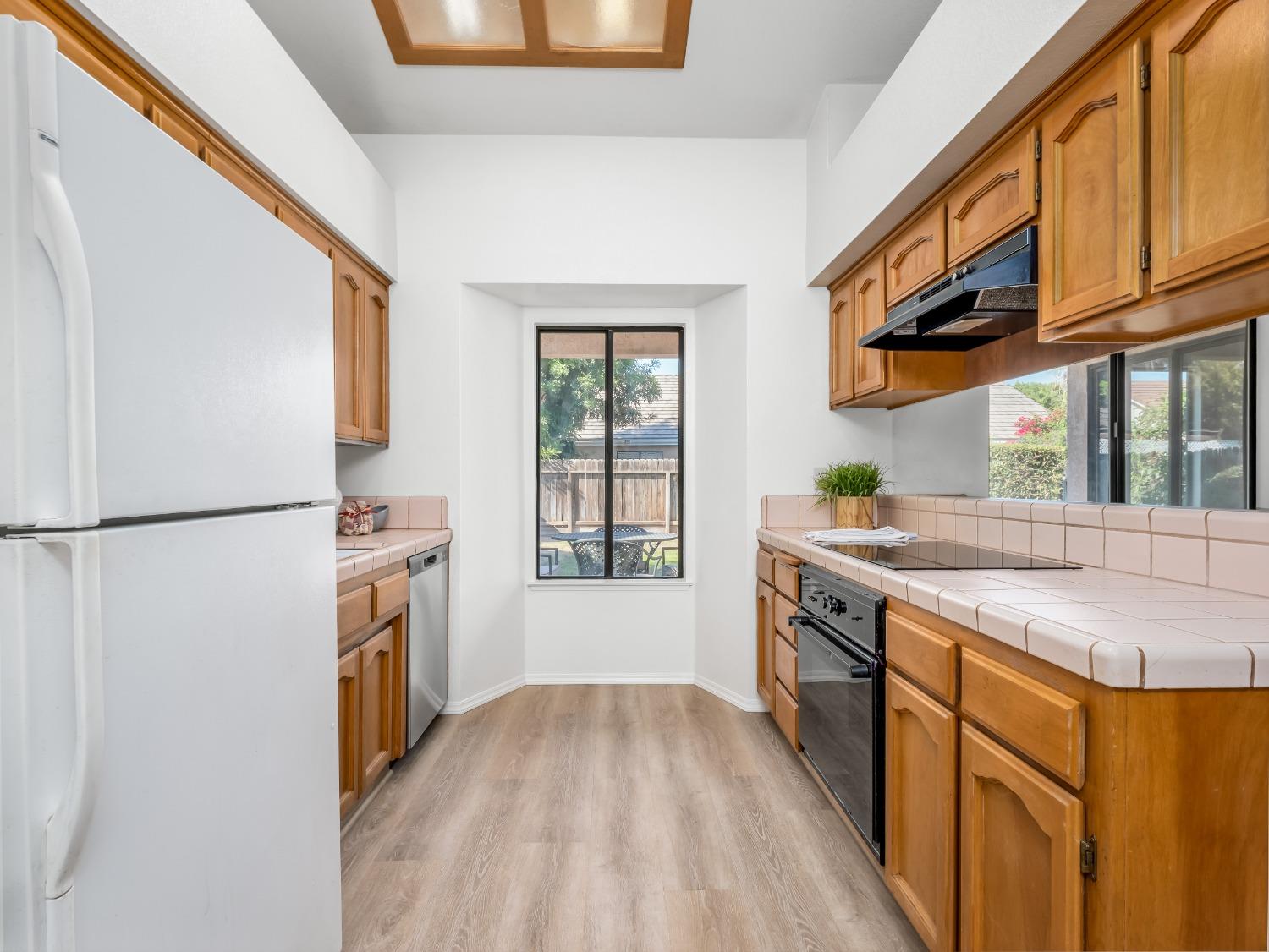 2048 Maple Street Selma, CA 93662 - Photo 6 of 20 a kitchen with stainless steel appliances granite countertop a refrigerator a stove and a sink with cabinets