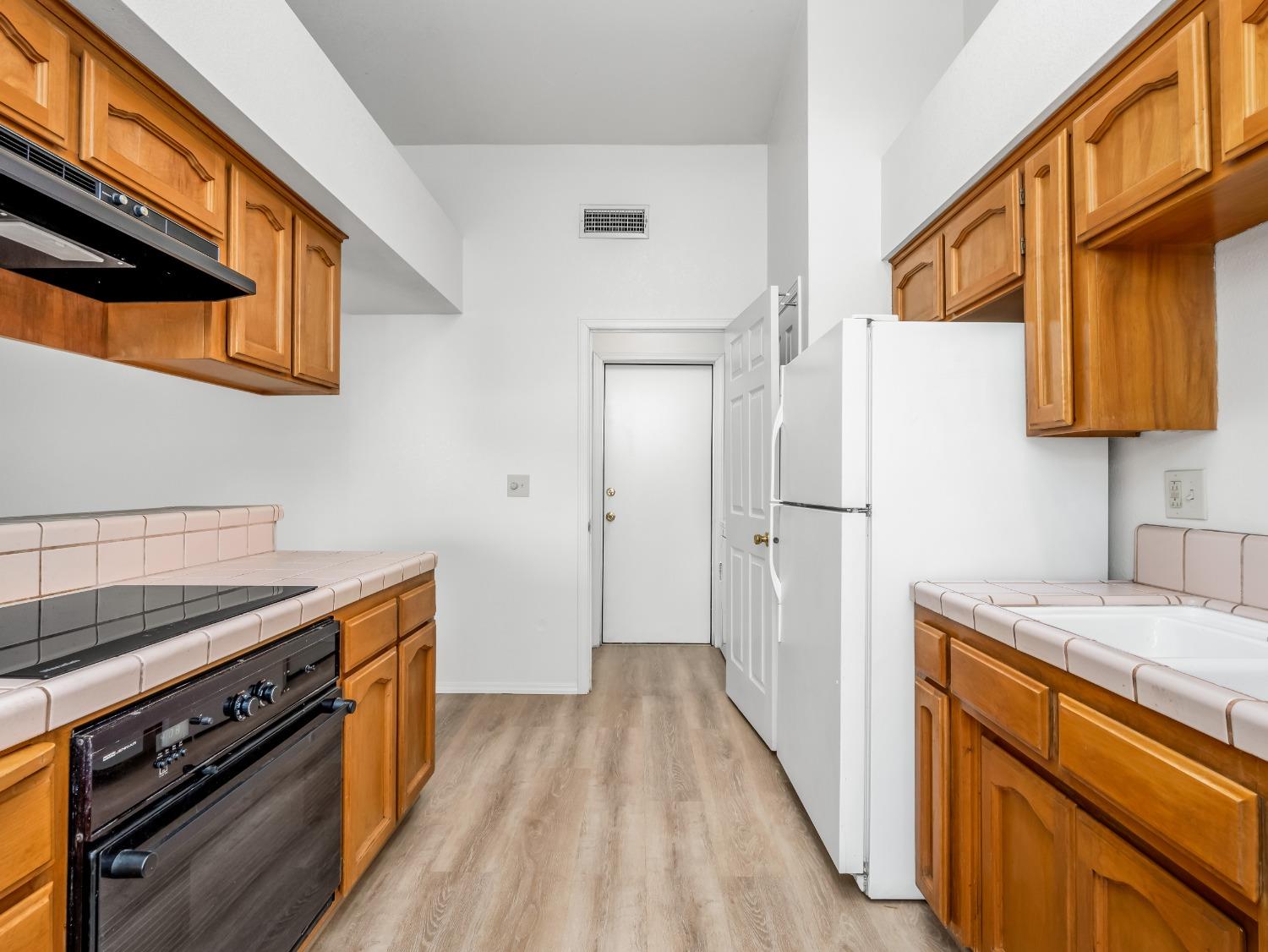 2048 Maple Street Selma, CA 93662 - Photo 7 of 20 a kitchen with a stove and a refrigerator