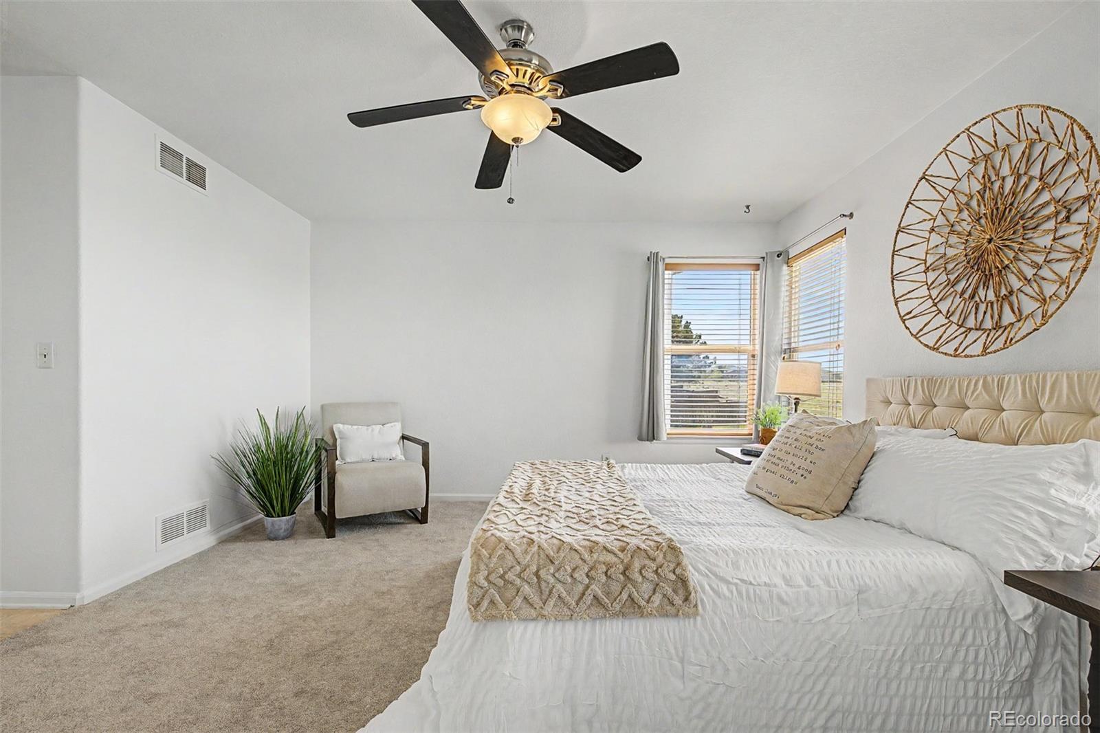 9917 Aftonwood Street Highlands Ranch, CO 80126 - Photo 21 of 48 a bedroom with a bed and a chandelier
