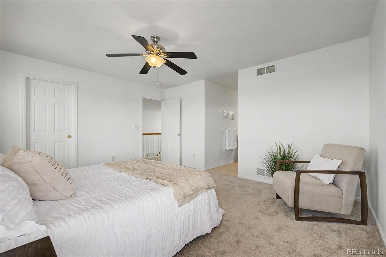 9917 Aftonwood Street Highlands Ranch, CO 80126 - Photo 22 of 48 a bedroom with a bed and a chandelier