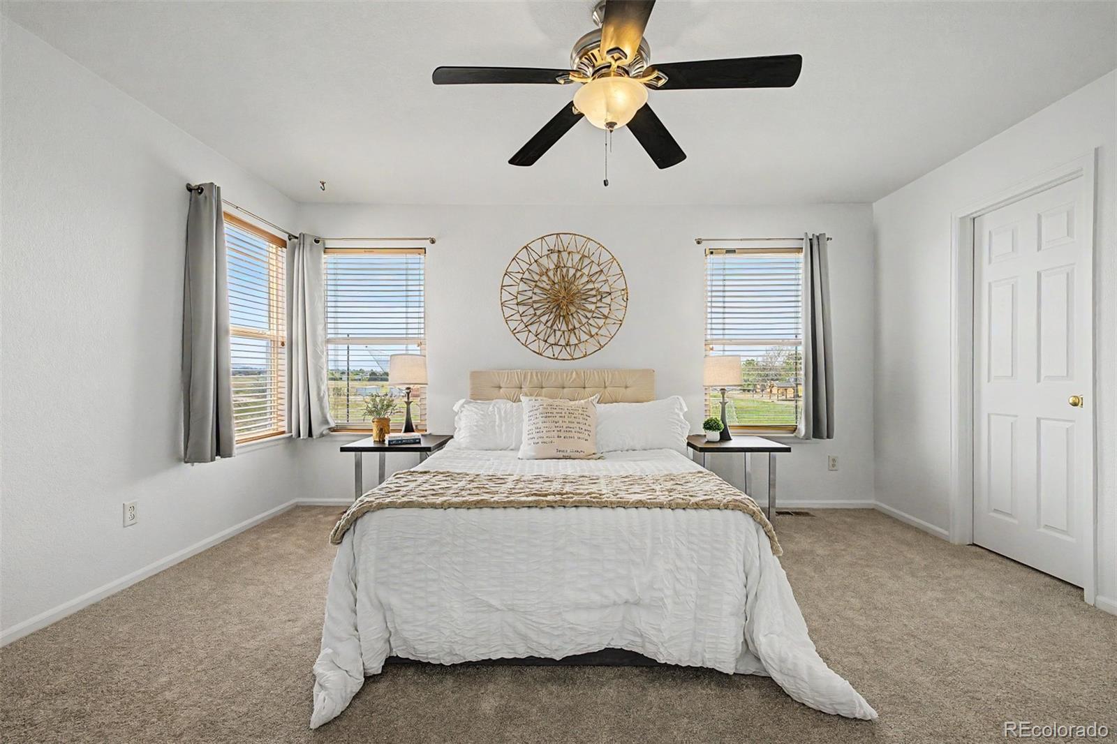 9917 Aftonwood Street Highlands Ranch, CO 80126 - Photo 23 of 48 a bedroom with a bed chandelier and a window