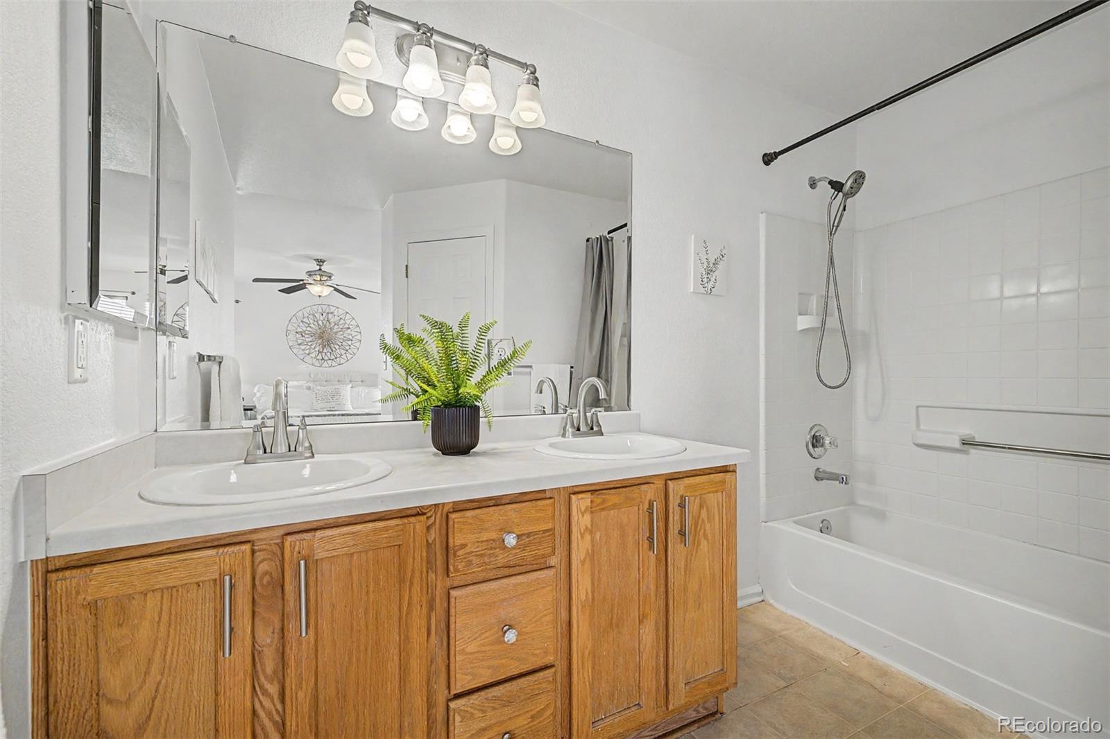 9917 Aftonwood Street Highlands Ranch, CO 80126 - Photo 24 of 48 a bathroom with a granite countertop sink a toilet and shower
