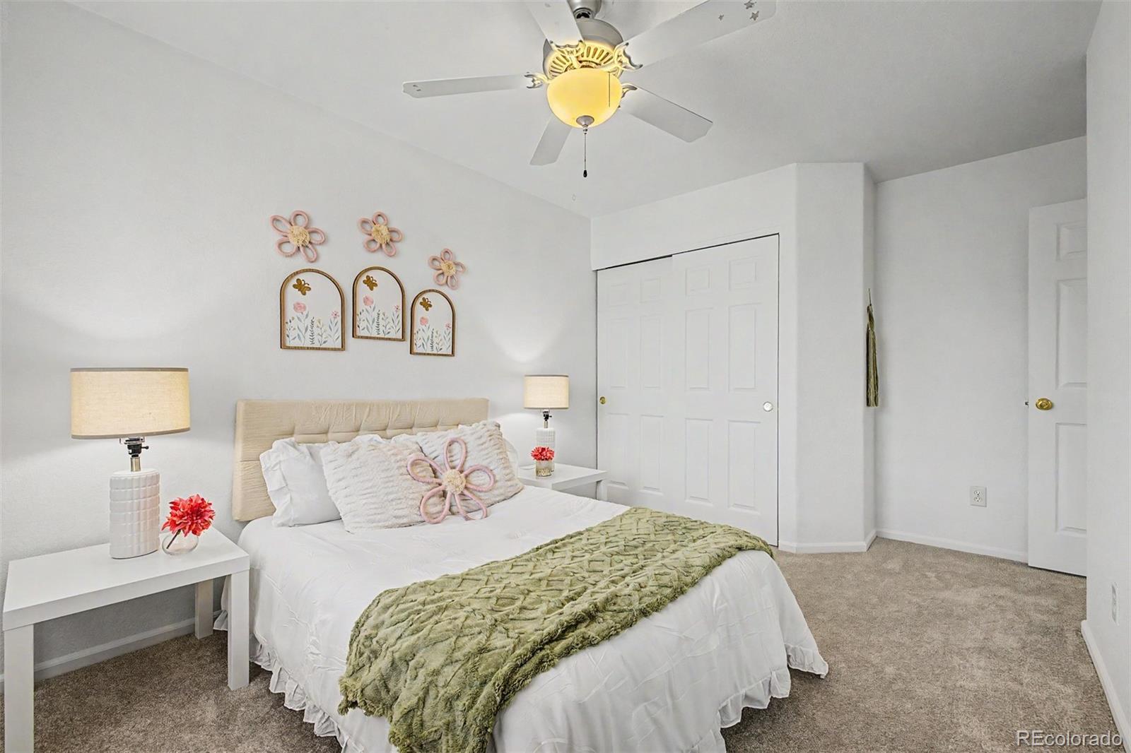 9917 Aftonwood Street Highlands Ranch, CO 80126 - Photo 27 of 48 a bedroom with a bed and a chandelier