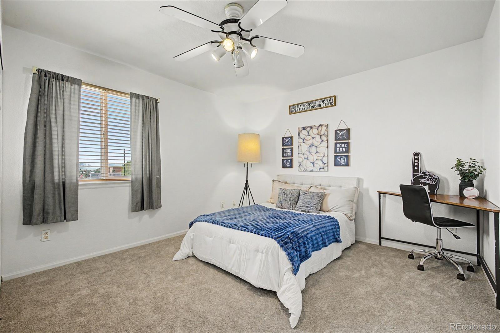 9917 Aftonwood Street Highlands Ranch, CO 80126 - Photo 28 of 48 a bedroom with a bed and a chandelier