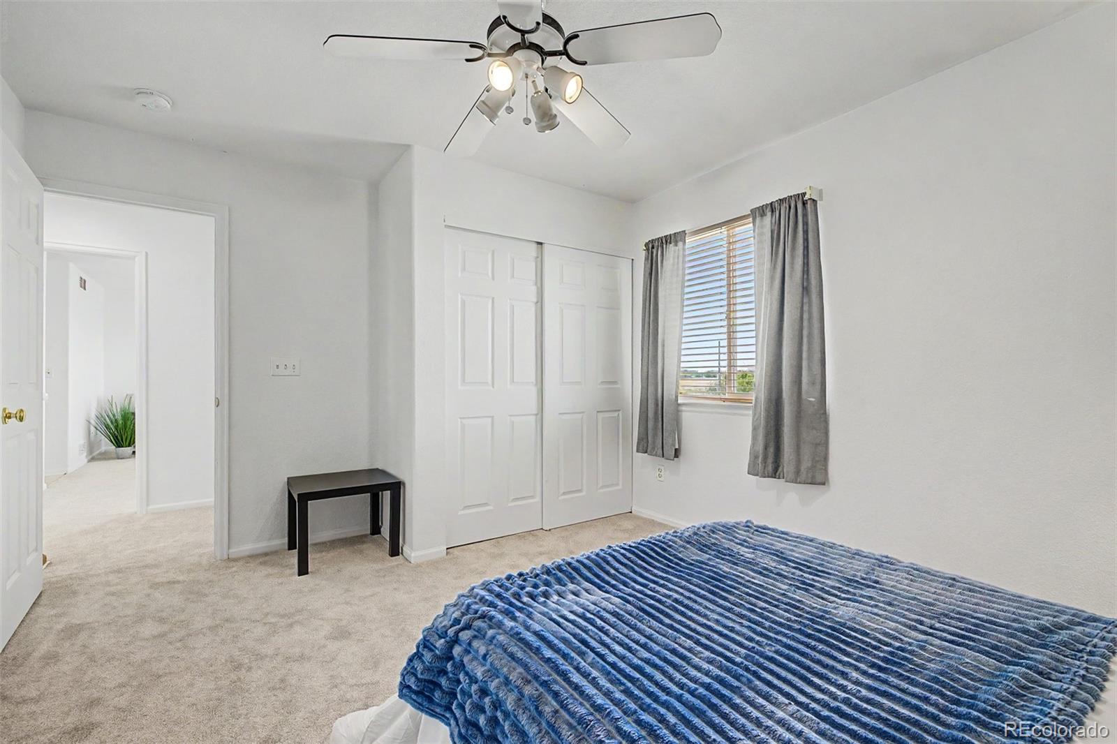 9917 Aftonwood Street Highlands Ranch, CO 80126 - Photo 29 of 48 a bedroom with a bed and a chandelier