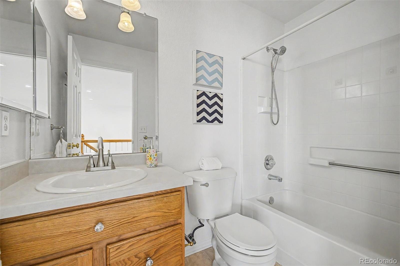 9917 Aftonwood Street Highlands Ranch, CO 80126 - Photo 30 of 48 a bathroom with a sink a toilet and shower