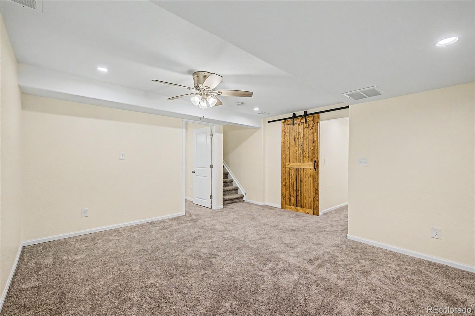 9917 Aftonwood Street Highlands Ranch, CO 80126 - Photo 31 of 48 a view of an empty room with a chandelier fan