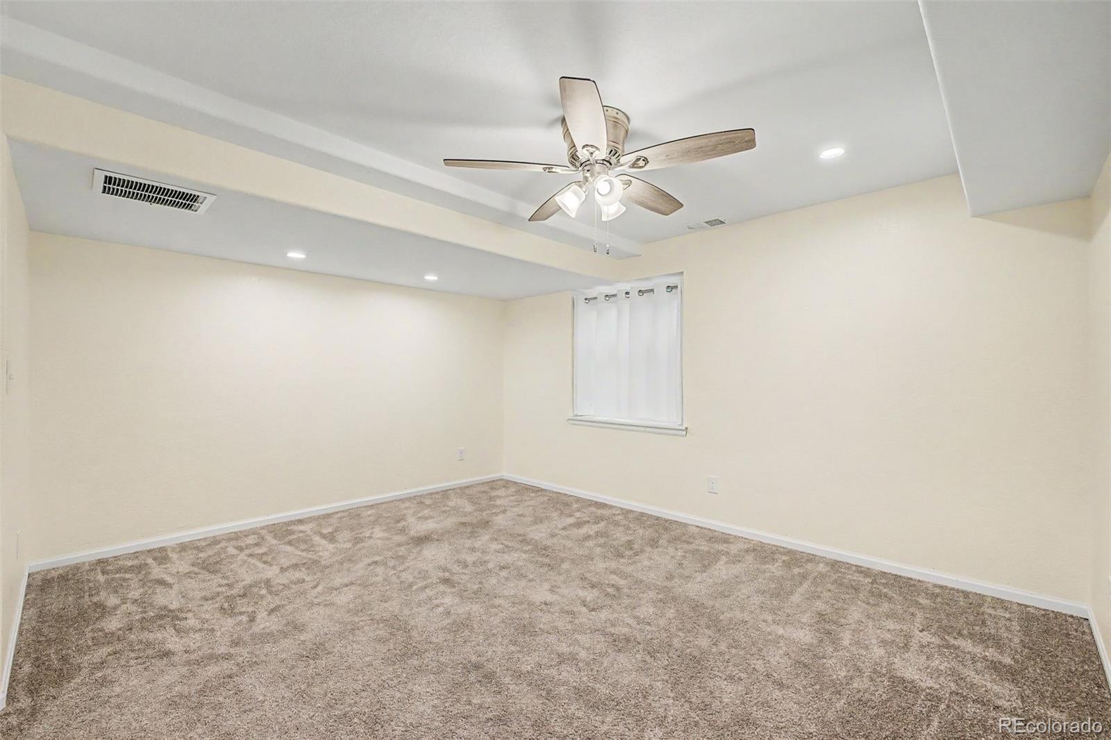 9917 Aftonwood Street Highlands Ranch, CO 80126 - Photo 32 of 48 an empty room with a window and ceiling fan