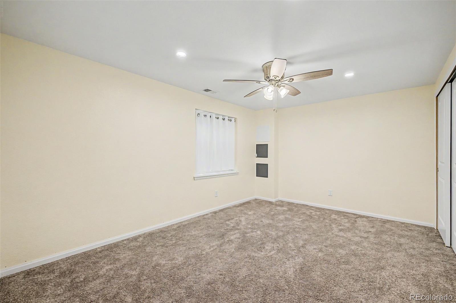 9917 Aftonwood Street Highlands Ranch, CO 80126 - Photo 33 of 48 an empty room with windows and ceiling fan