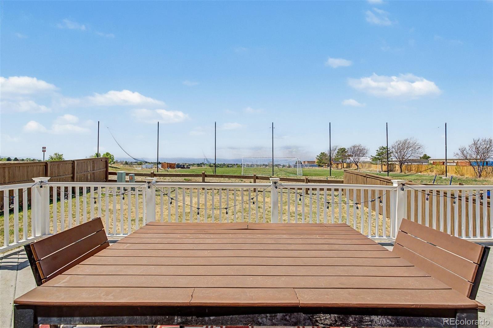 9917 Aftonwood Street Highlands Ranch, CO 80126 - Photo 4 of 48 a view of a balcony with wooden chairs