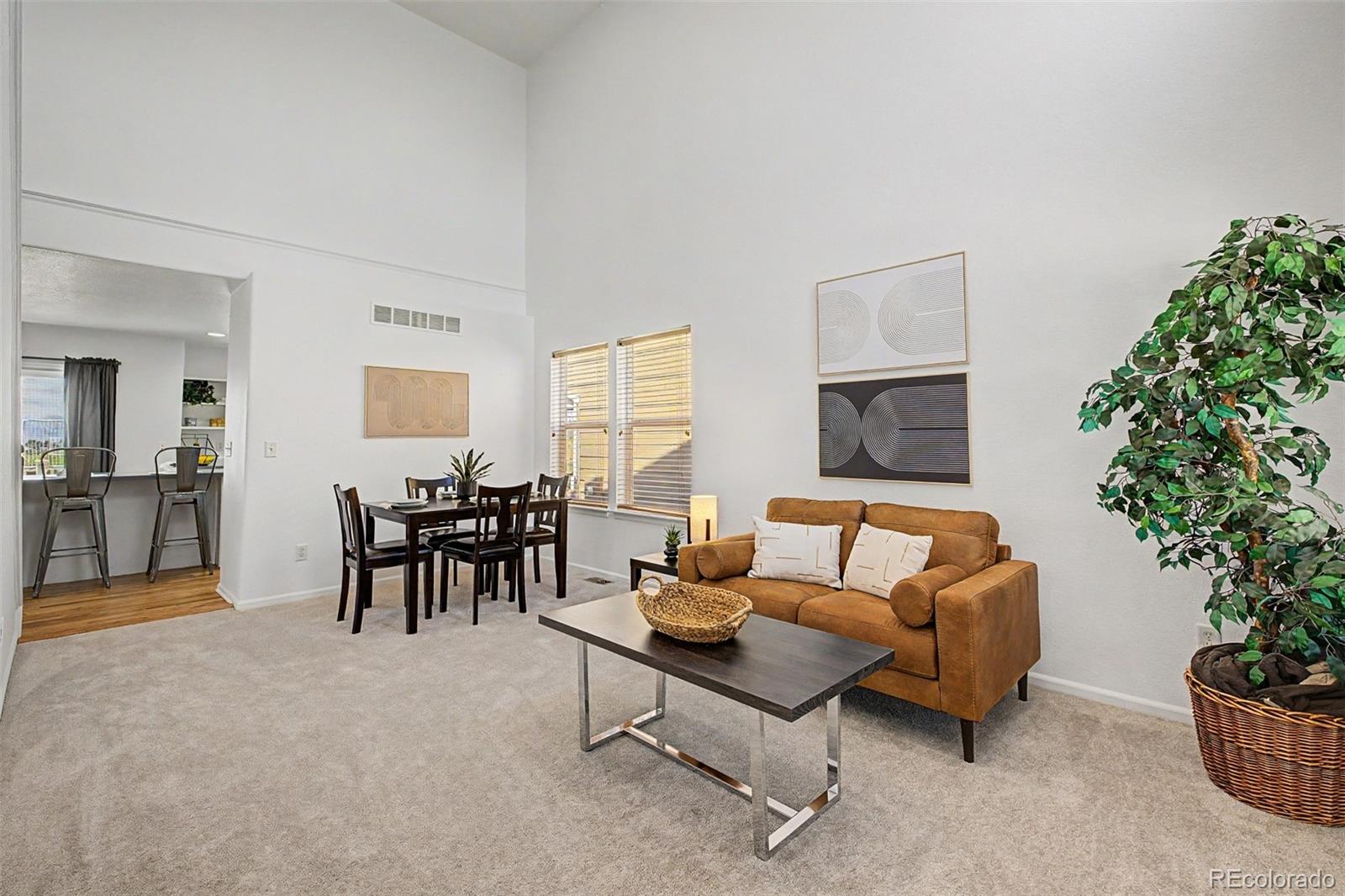 9917 Aftonwood Street Highlands Ranch, CO 80126 - Photo 5 of 48 a living room with furniture potted plant and a window