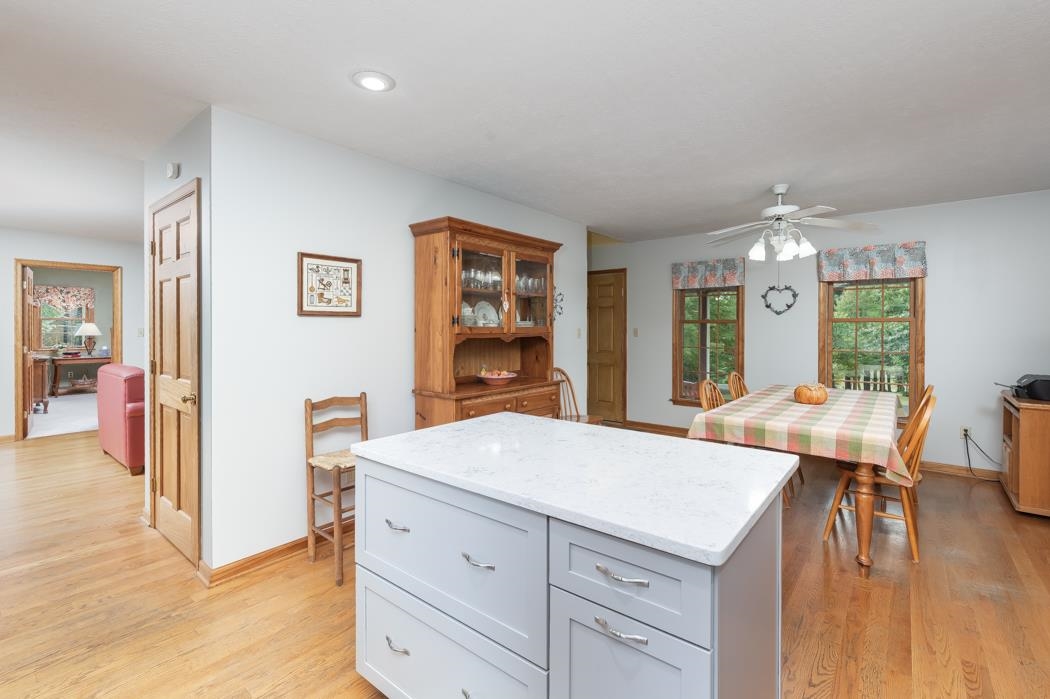 1284 Limestone Road Mount Sidney, VA 24467 - Photo 21 of 65 a living room with stainless steel appliances kitchen island granite countertop a refrigerator a stove a dining table and chairs with wooden floor