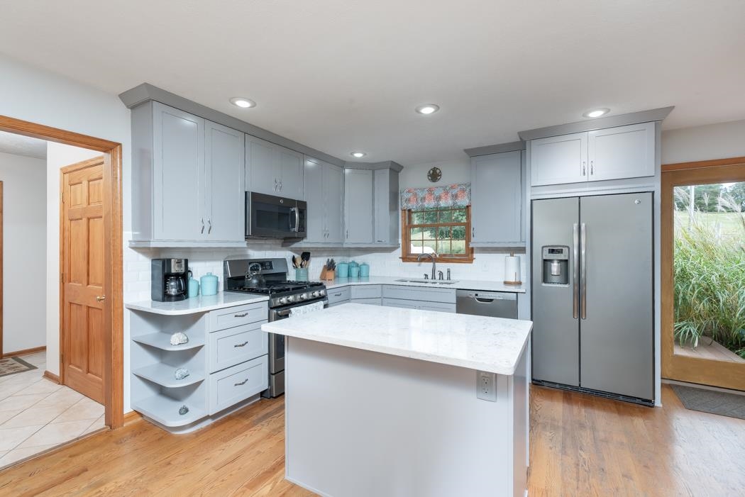 1284 Limestone Road Mount Sidney, VA 24467 - Photo 28 of 65 a kitchen with stainless steel appliances granite countertop a refrigerator oven a sink dishwasher and white cabinets with wooden floor