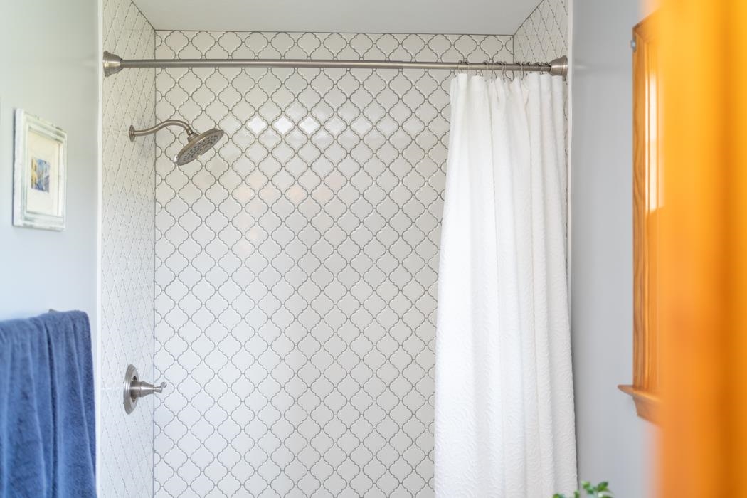 1284 Limestone Road Mount Sidney, VA 24467 - Photo 44 of 65 a bathroom with a shower curtain and a curtain next to a window