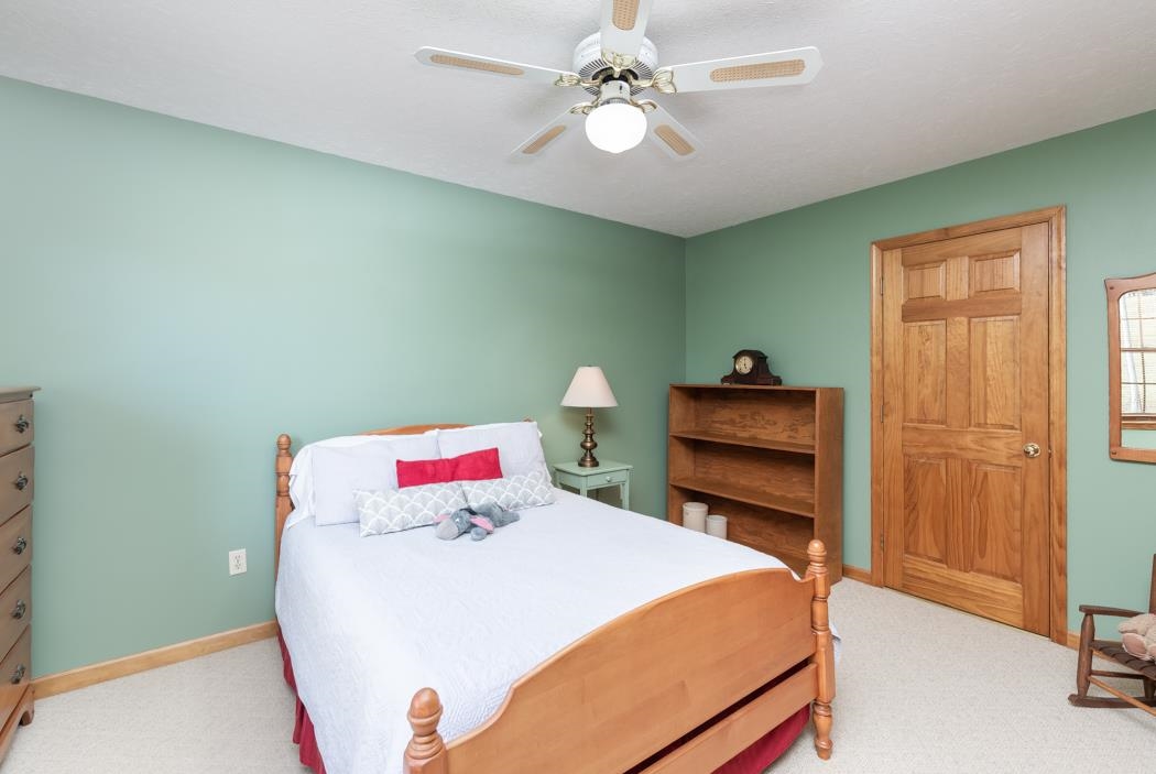 1284 Limestone Road Mount Sidney, VA 24467 - Photo 47 of 65 a bedroom with a bed and a chandelier