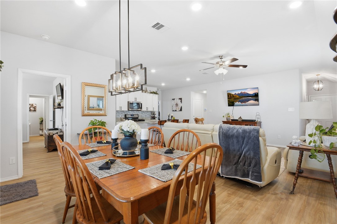 2425 Mulligan Lane Navasota, TX 77868 - Photo 17 of 48 a dining room with furniture a chandelier and wooden floor