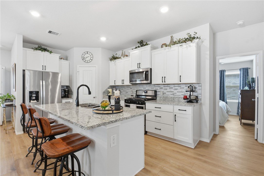 2425 Mulligan Lane Navasota, TX 77868 - Photo 20 of 48 a kitchen with white cabinets and appliances
