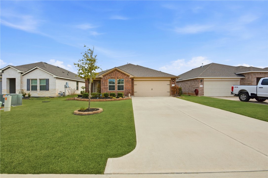 2425 Mulligan Lane Navasota, TX 77868 - Photo 2 of 48 a front view of a house with garden