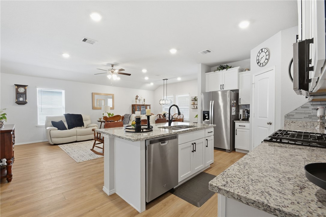 2425 Mulligan Lane Navasota, TX 77868 - Photo 22 of 48 a kitchen with stainless steel appliances granite countertop a lot of counter space and wooden floor
