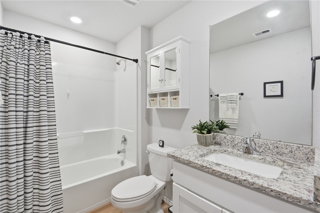 2425 Mulligan Lane Navasota, TX 77868 - Photo 26 of 48 a bathroom with a granite countertop sink toilet and shower
