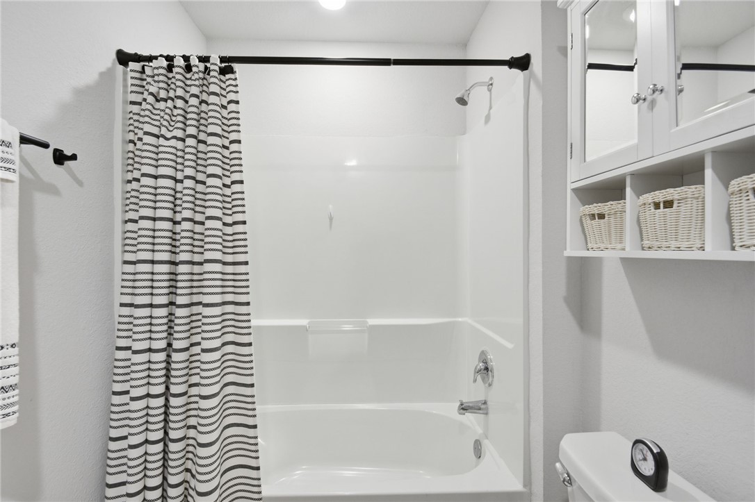 2425 Mulligan Lane Navasota, TX 77868 - Photo 27 of 48 a bathroom with a bathtub and a shower