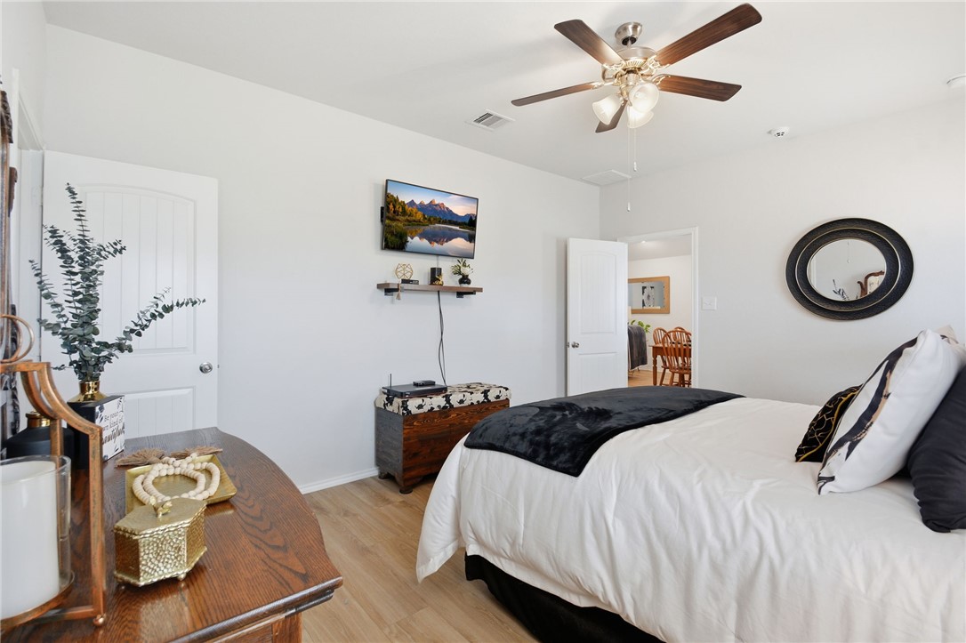 2425 Mulligan Lane Navasota, TX 77868 - Photo 32 of 48 a bedroom with a bed and a chandelier