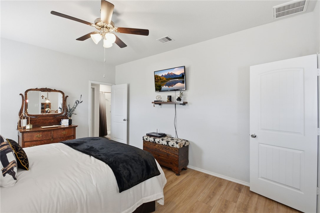 2425 Mulligan Lane Navasota, TX 77868 - Photo 33 of 48 a bedroom with a bed and a chandelier