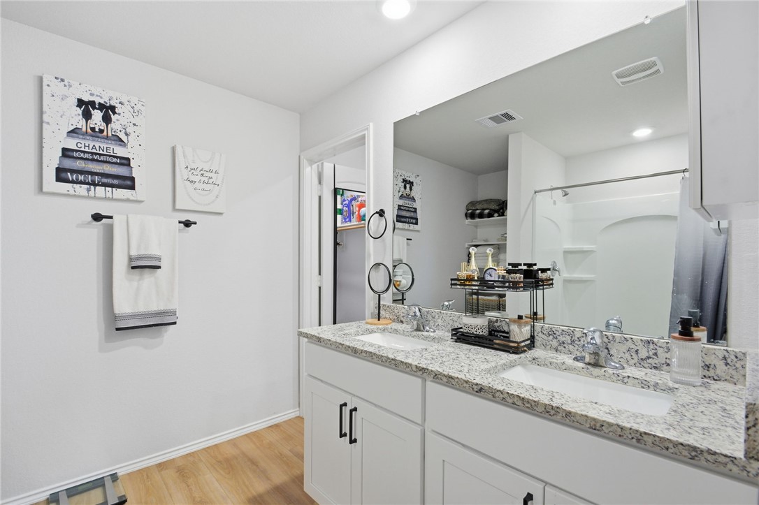 2425 Mulligan Lane Navasota, TX 77868 - Photo 35 of 48 a bathroom with a granite countertop sink and a mirror