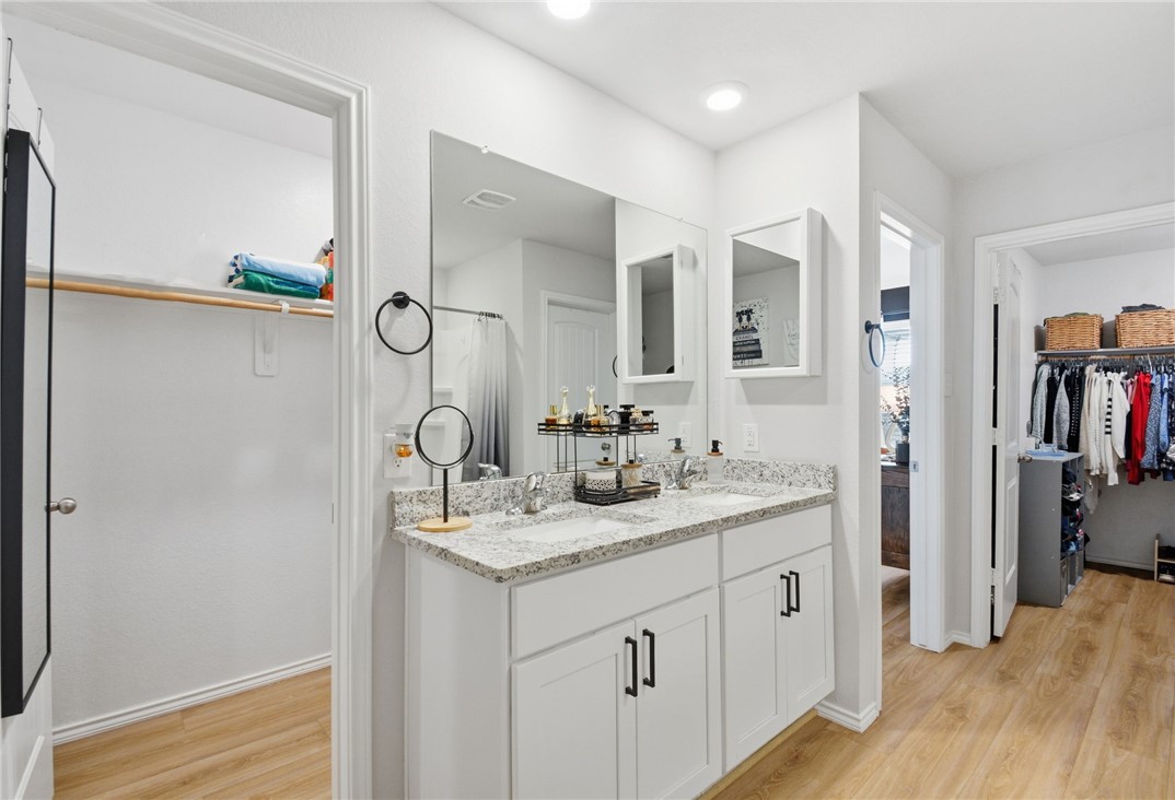 2425 Mulligan Lane Navasota, TX 77868 - Photo 38 of 48 a en suite bathroom with a double vanity sink and a mirror