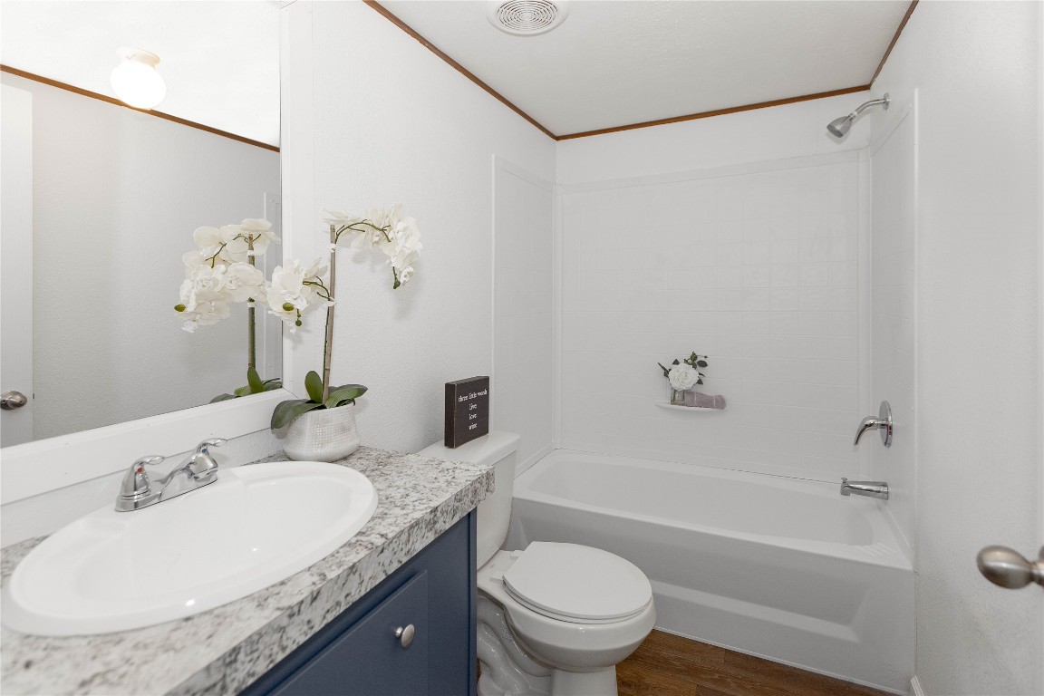 145 Crooked Road Dale, TX 78616 - Photo 13 of 26 a bathroom with a granite countertop sink a toilet and bathtub